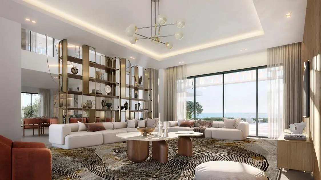 Spacious living room in Nawayef East villa with panoramic windows, neutral palette, and contemporary furnishings.